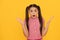 OMG. Surprised child yellow background. Wide-eyed girl got surprised. Surprise and shock