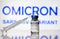 Omicron COVID-19 variant and corona virus vaccine, focus on vaccine bottle and syringe