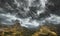 Ominous black and gray storm clouds over the mountains, generated by artificial intelligence