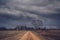 Ominous clouds over an abandoned farm house