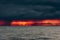 Ominous fiery dawn on the sea