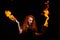 An ominous witch sets her spell book on fire with the power of thought. Red-haired woman conjures for Halloween. Flames