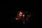 An ominous witch sets her spell book on fire with the power of thought. Red-haired woman conjures for Halloween. Flames