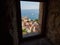 Omis, Croatia - July 23, 2021: Narrow view of the old town of Omis through the window of the Mirabela fortress. Interesting shot