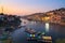 Omkareshwar cityscape at dusk, India, sacred hindu temple. Holy Narmada River, boats floating. Travel destination for tourists and