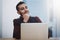 Once he dreams it, he does it. a young businessman looking thoughtful while working on a laptop in an office.