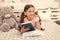 Once upon a time. Girl child in bed read book with teddy bear plush toy. Pleasant time in cozy bedroom. Girl kid long