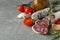 Ð¡oncept of tasty food with salami sausage on gray textured background