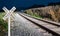 Oncoming train with railroad crossing sign