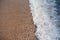 Oncoming waves on a beach sand