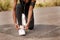 One african american female athlete tying her laces before starting her outdoor workout. A dedicated black woman