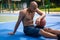 One african-american male basketball player playing at street public stadium, sport court or palyground outdoors