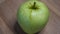 One apple of the Reinette Simirenko variety, video. Green apple close up.