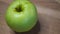 One apple of the Reinette Simirenko variety, video. Green apple close up.