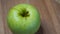 One apple of the Reinette Simirenko variety, video. Green apple close up.