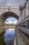 One of the arches of the Toledo bridge seen in Madrid Rio park one day with rain clouds hovering