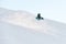 One-armed male skier descends a snowy slope and the snow flies in directions