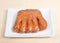 One Bear Claw donut on rectangular plate