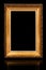 One beautiful old antique empty wooden gold frame on black background.