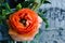 One beauty, spring orange, persian flower buttercup ranunculus macro. Rustic style, still life. Colorful holiday