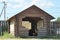 One big  brown wooden gazebo made of logs