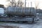 One big dirty gray iron barrel cistern on a truck trailer