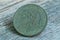 One big old green copper coin with an eagle