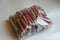 One big pack of bully sticks on a light background. Pieces about 4-5 inches long. Natural treats for dogs. Air dried chew. Dried b