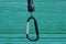 One black metal carabiner clasp on a plastic wire