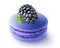 One blackberry fruit on top of blue macaroon, isolated on white background