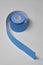 One blue kinesio tape rolling