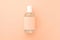 one bottle of perfume against the background of the color of the year 2024 Peach Fuzz