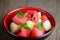 One bowl of mixed tropical fruit salad: watermelon and melon on a wooden table. Juicy vitamin salad of summer.