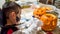 One boy in halloween costume and makeup drawing on pumpkin with pen for decorating holiday of Halloween at home. Autumn, fall,