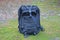 one brack army backpack stands on gray ground