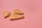 One broken square cookie lies on pink desk on kitchen