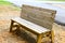 One brown isolated bench on a summer day