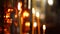 One burning candle in focus, the Orthodox church