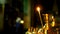 One candle burns in golden candlestick of the Orthodox Church