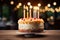 One candle shines brightly on a mouthwatering birthday cake