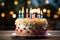 One candle shines brightly on a mouthwatering birthday cake