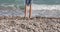 One child on seashore wets feet 4k