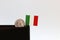 One coin of Italy Lire money and mini Italy flag stick on the black wallet with white background. REPVBBLICA ITALIANA, Lire Italia