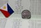 One coin of Philippine peso money on reverse and mini Philippine flag on the book bank. Concept of Saving money