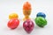 One colored Easter egg in eggcup and five another around