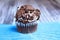 One cookies and cream cupcake on a blue stand wooden background