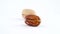 One cracked pecan nut and kernel pecan nut. Slowly rotating on the turntable isolated on the white background. Closeup