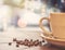 One cup of coffee and coffee beans on a wooden board