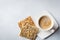 One cup of coffee with useful bread with sunflower seeds ,flax and sesame on light concrete or stone background. Selective focus.