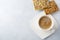 One cup of coffee with useful bread with sunflower seeds ,flax and sesame on light concrete or stone background. Selective focus.